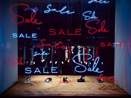 Sign depicting sale at a retail store to indicate human need for bargain