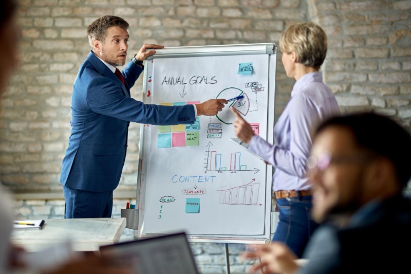 Businessman talking his colleague while presenting new business strategy