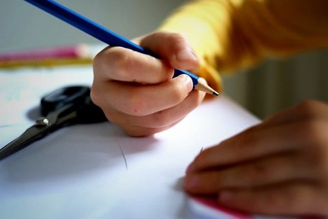 child writing in the  notes