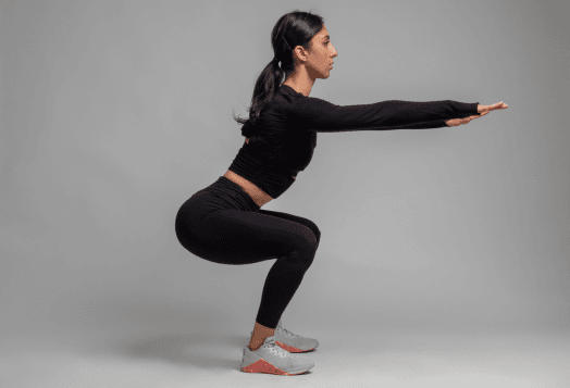 Woman in black activewear doing a squat
